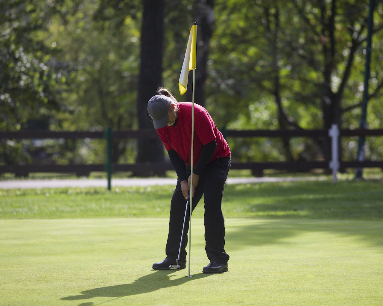 Golfer tapping in putt