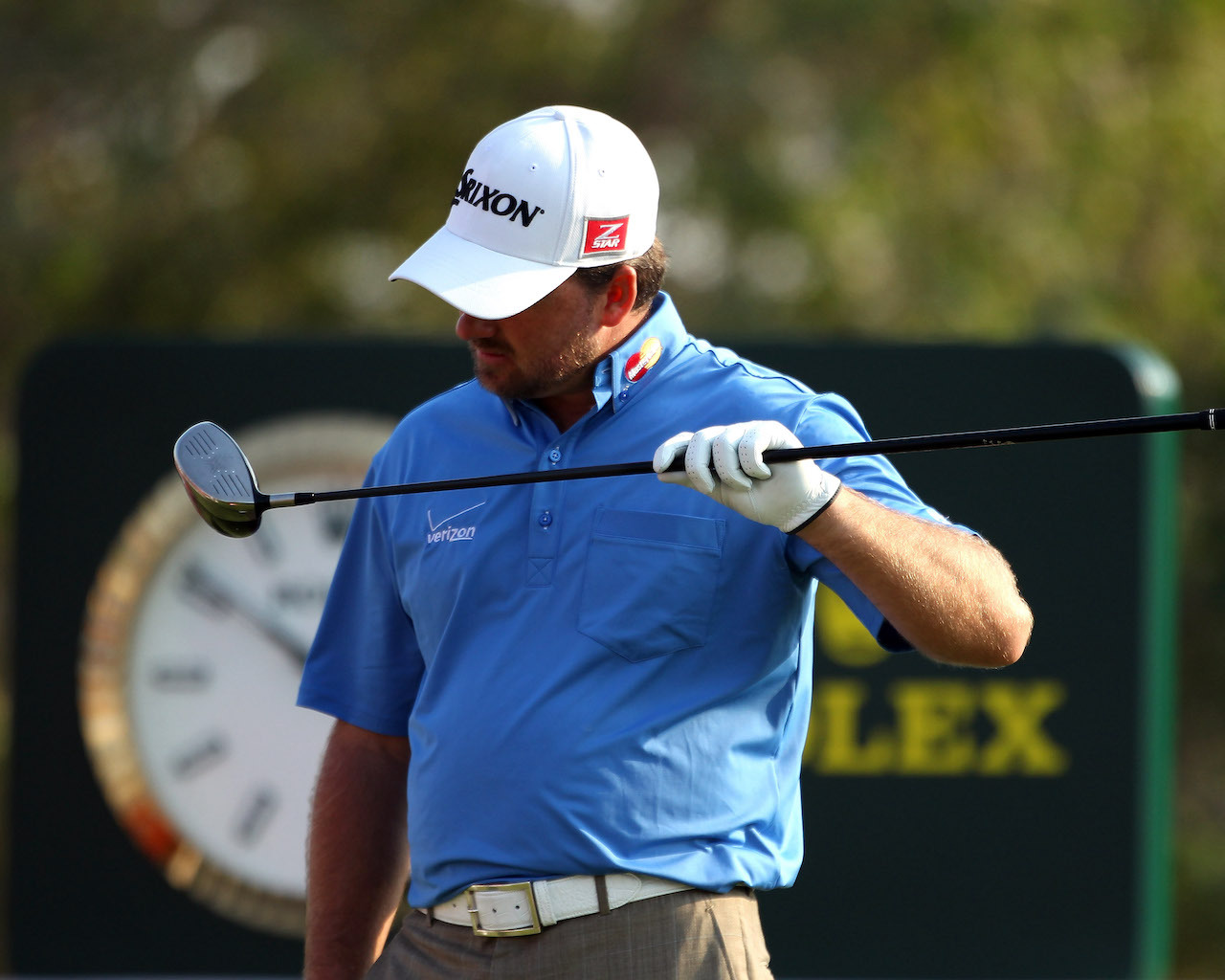 Graeme McDowell checking driver for damage