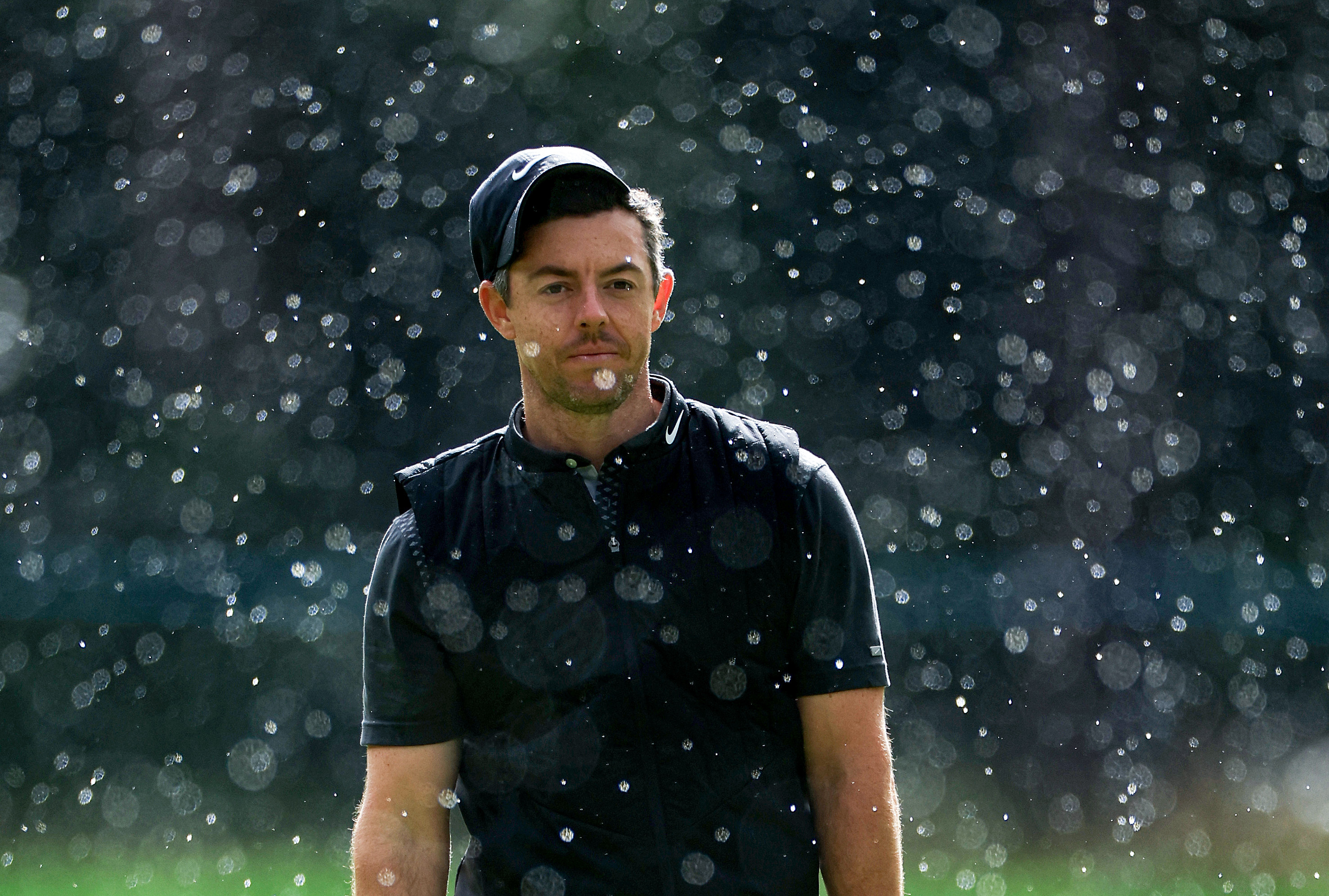 Rory McIlroy plays golf in heavy rain