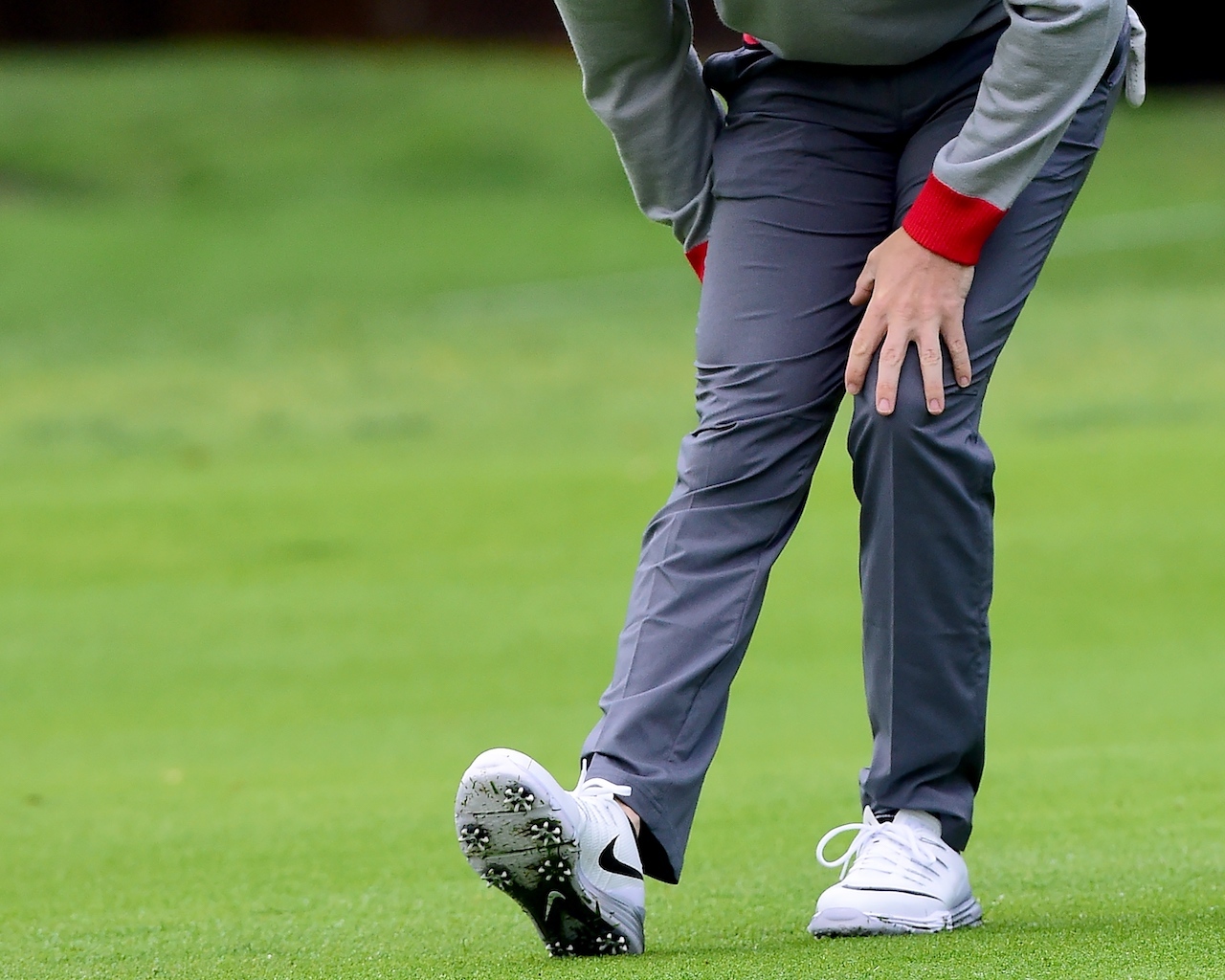 Golfer stretching legs before round