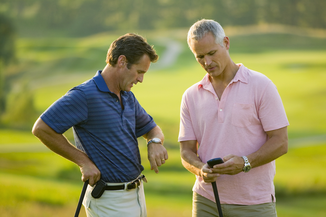 two golfers checking the time