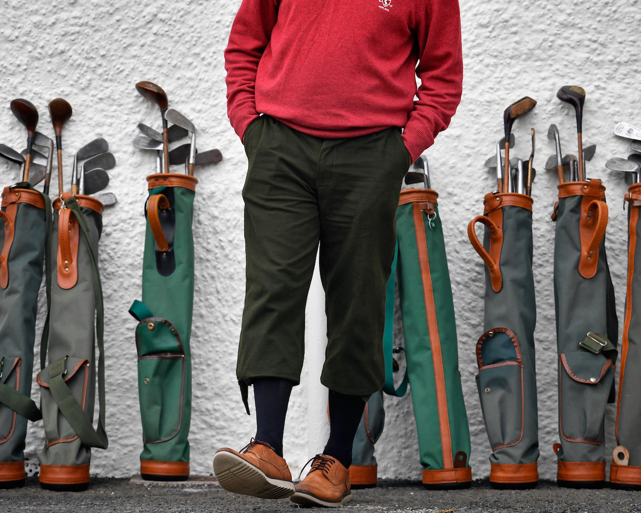 Used golf clubs behind golfer