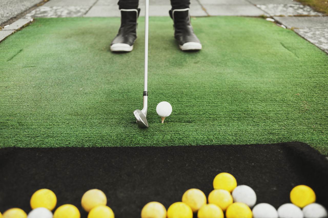 Ball on tee at driving range Ball on tee at driving range