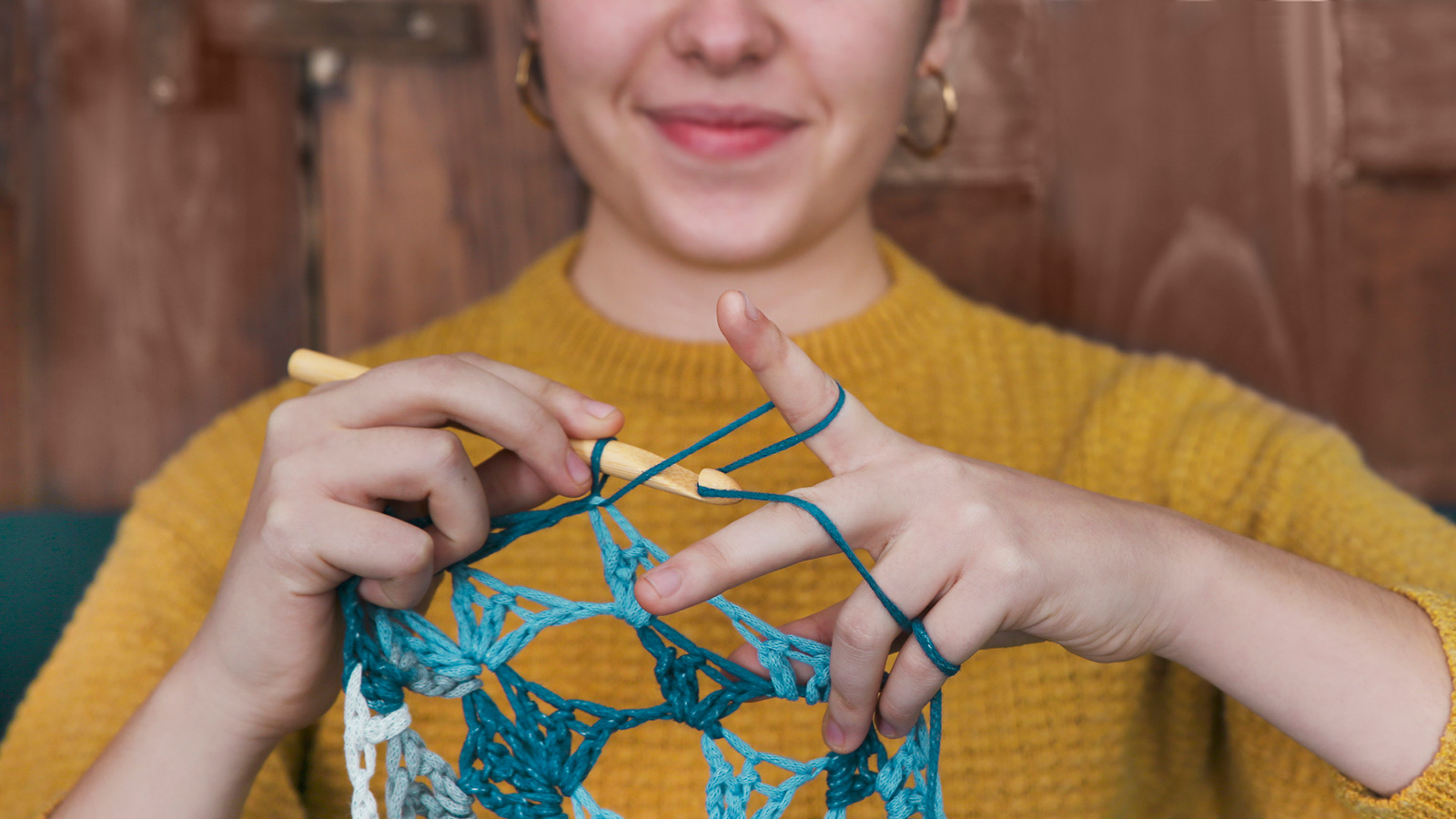 woman crocheting doily