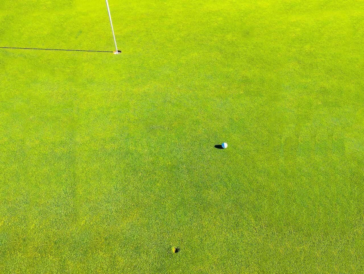 divot from golf ball near hole