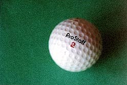 Golf ball close-up on felt Golf ball close-up on felt