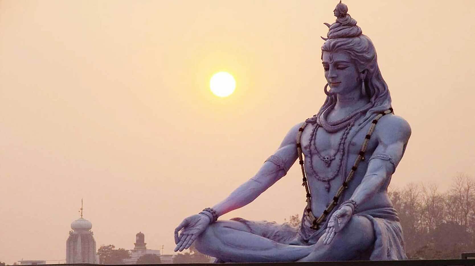hindu god shiva statue at sunrise