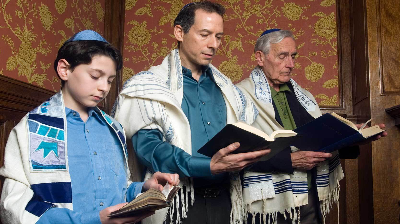religious social institutions with three generations reading Torah